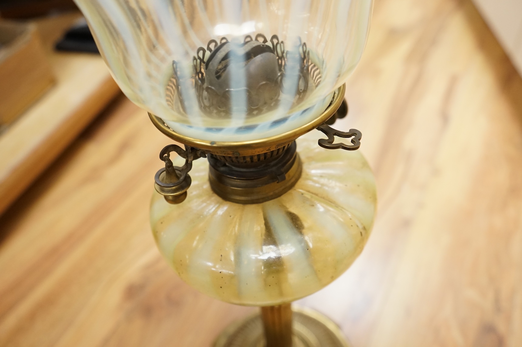 An Edwardian vaseline glass and brass oil lamp and shade, 56cm high